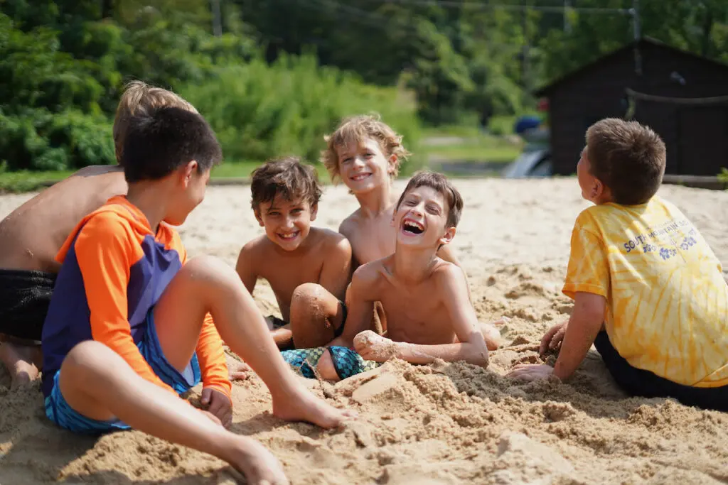 Male campers enjoying playtime on the beach at SLC