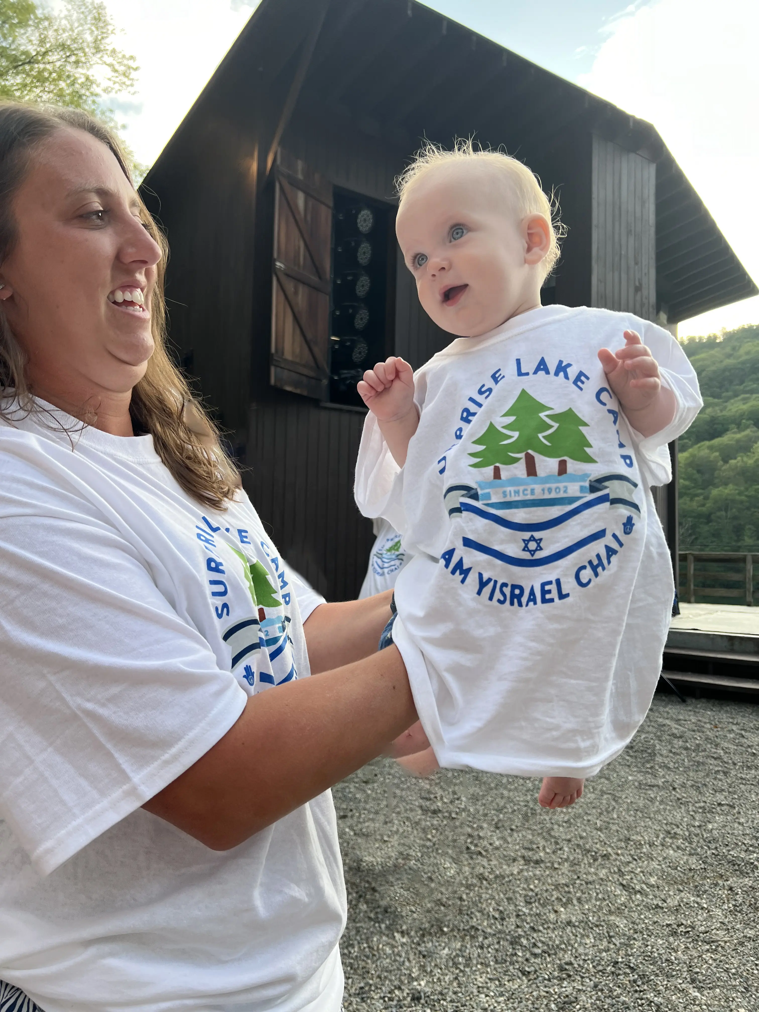 A baby wearing an SLC shirt