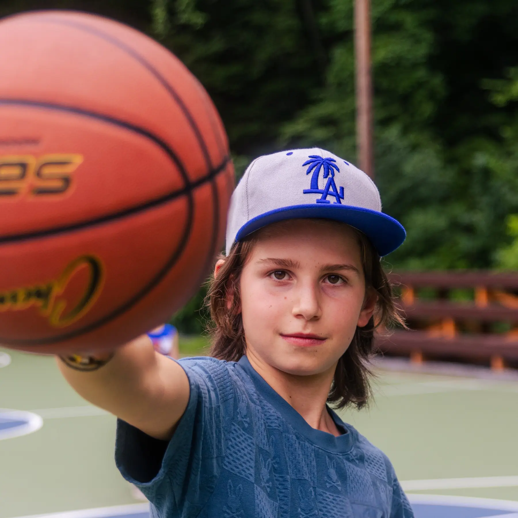 Young male camper holding a basketball